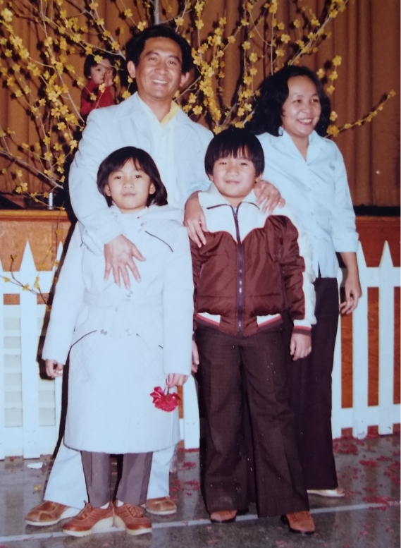 A young, Asian family of four in the early eighties.