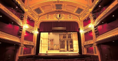 Stage with red curtains and sets of a town