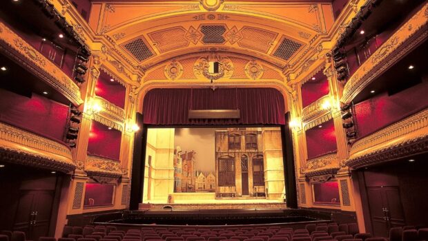 Stage with red curtains and sets of a town